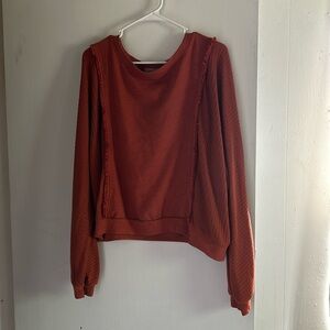 Burnt orange sweater.
